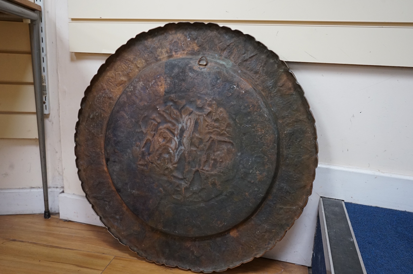 A circular Persian tinned copper embossed tray 88cm diameter